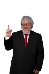 Grey haired senior wearing a dark suit and a red necktie