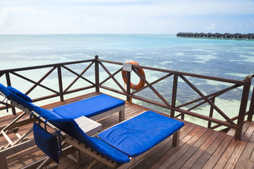 Fototapeta premium Two chairs on the water villa resort
