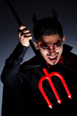 Man in devil costume in halloween concept