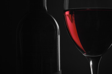 bottle with red wine and glass