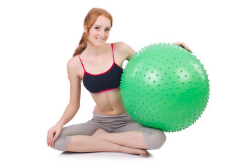 Woman exercising with swiss ball on white