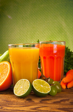Fresh vegetable and fruits juices on wood 
