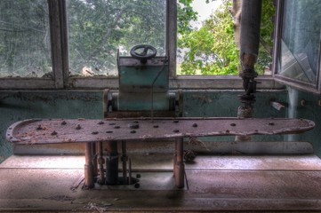 Fototapeta na wymiar old iron machine in abandoned laundry