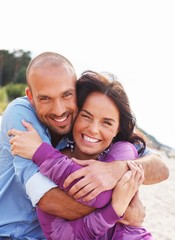 Happy smiling middle-aged couple on a beach