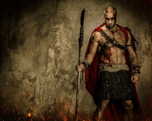 Fototapeta na wymiar Wounded gladiator in red coat holding spear