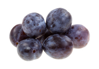 Group of small Italian plums on a white background