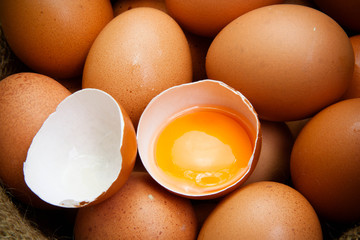 broken chicken eggs and egg yolk - obrazy, fototapety, plakaty