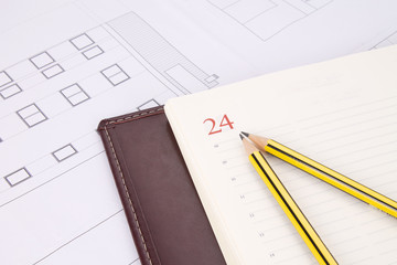 planos de edificio con lápices y agenda