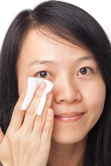 Woman cleansing face