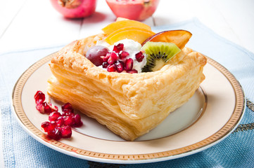 Delicious puff pastry with cream and fruits - 57447881