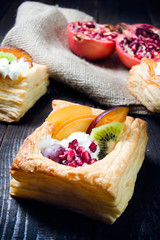 Delicious puff pastry with cream and fruits - 57447884