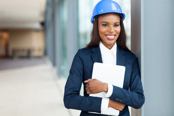 african construction engineer holding laptop computer