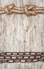 Metal chain and ship rope on the old wood