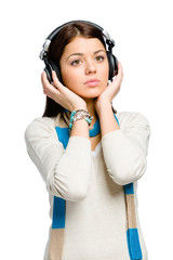 Half-length portrait of teenager listening to music in earphones