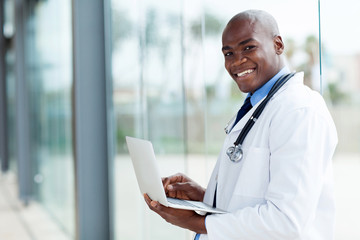afro american doctor using laptop computer