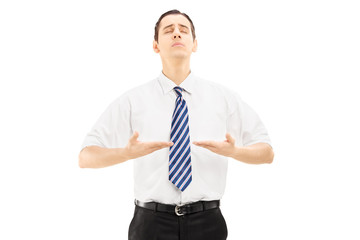 Young businessman meditating