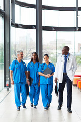 group of health care workers walking in hospital