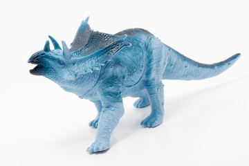 Blue toy dinosaur on a white background.
