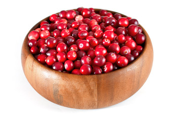 Ripe cranberry in wooden bowl