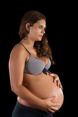 View of a young beautiful pregnant girl in the studio.