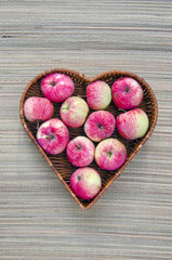 fresh summer apple in heart form basket