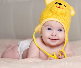 Fototapeten happy newborn baby  in a hat with an bruin © natalya kazakova