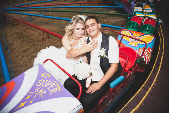 Newly married couple riding on roller coaster
