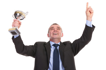 business man cheers with trophy in hand