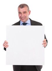 business man holds a small pannel with both hands