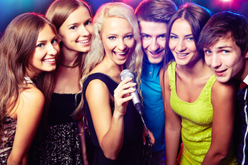 Fototapeta premium Young people singing at party