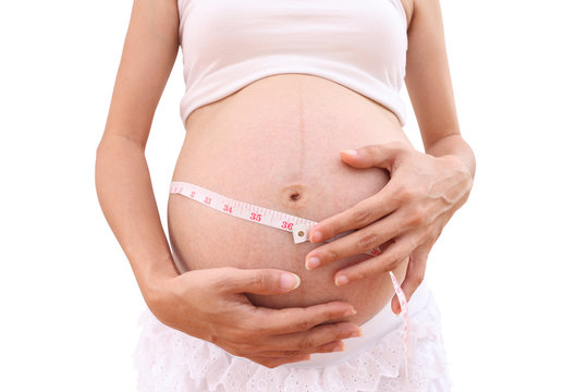 Face of pregnancy and tapeline abdomen on white background.