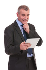 pensive business man with tablet