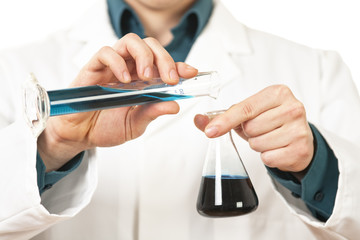 Scientiest pouring blue liquid
