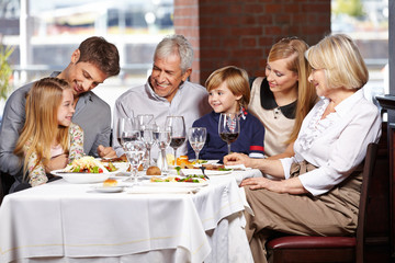 Happy family eating in restaurant