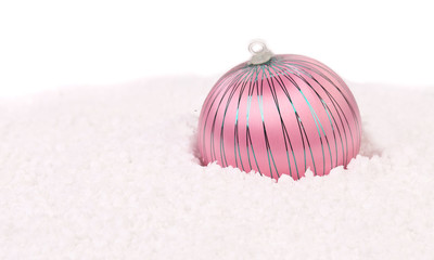 Purple christmas ball in snow.