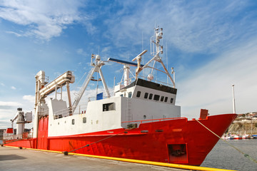Red freight pallet carrier ship moored in Norway