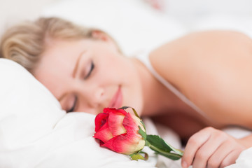 Obraz na płótnie Canvas Young woman with a rose sleeping