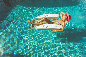 Blonde girl relaxing in pool