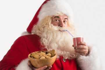 Portrait of Santa Claus Drinking milk from glass and holding bow