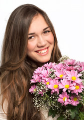 Naklejka premium portrait of a beautiful girl with long hair and a pink flowers