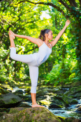 Beautiful Woman Practicing Yoga Outside In Nature