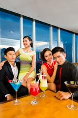 Chinese people drinking cocktails in luxury cocktail bar