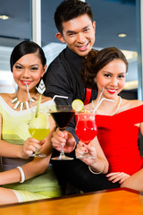Chinese people drinking cocktails in luxury cocktail bar