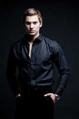 Obraz premium portrait of sexy macho man over dark background