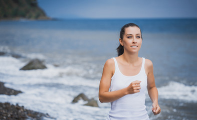 Fototapeta na wymiar athlete girl on morning jog on the beach