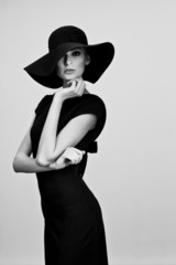 high fashion portrait of elegant woman in black and white hat an