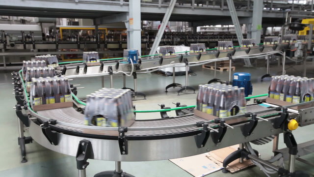 The brewery. Packaging of bottles moving on conveyor