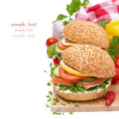 delicious burgers with smoked salmon and vegetables on board