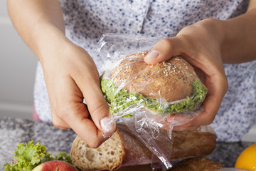 Mother foiling a sandwich