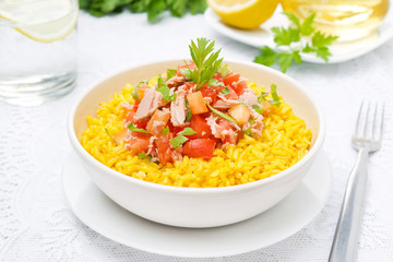 saffron rice with tuna, tomatoes, peppers and herbs in a bowl